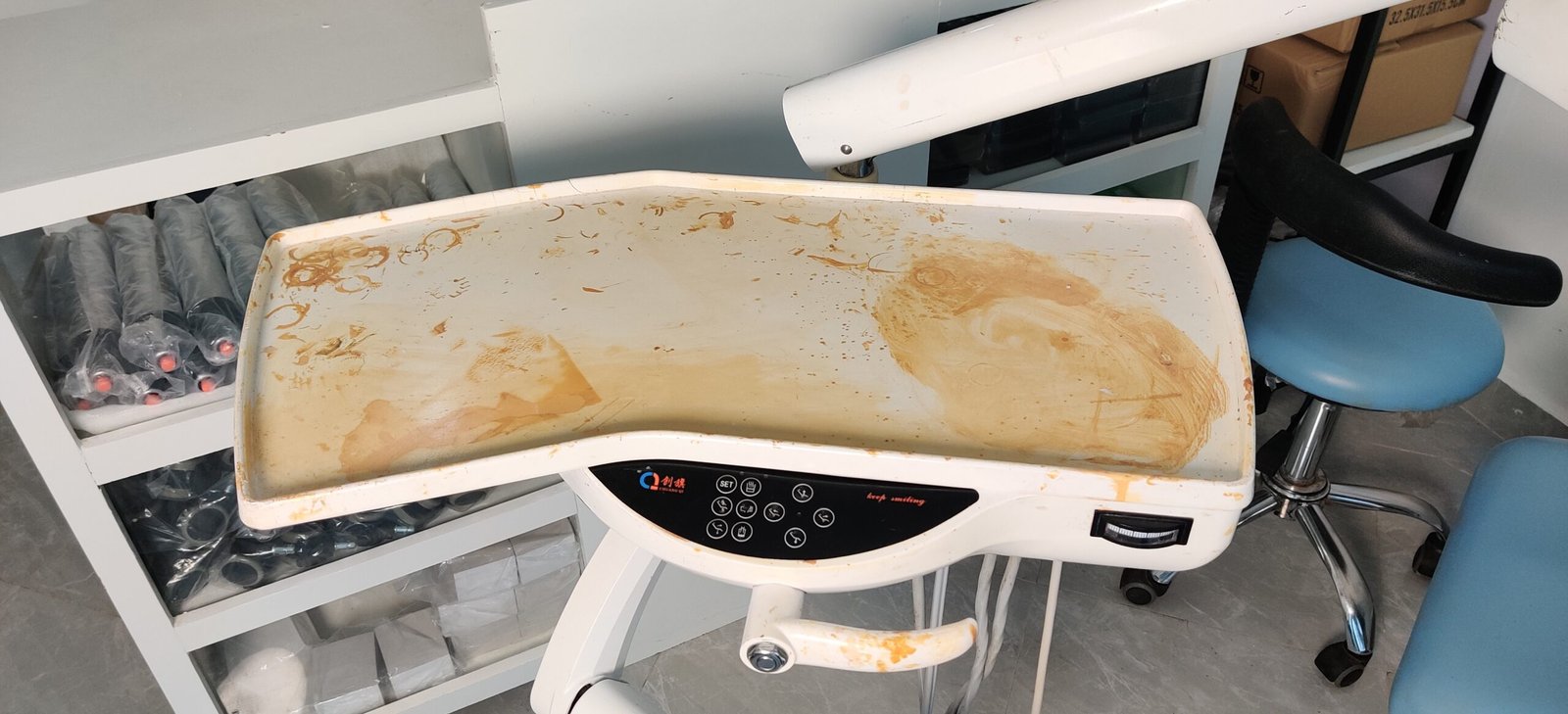 Discolored dental unit delivery tray before replacement